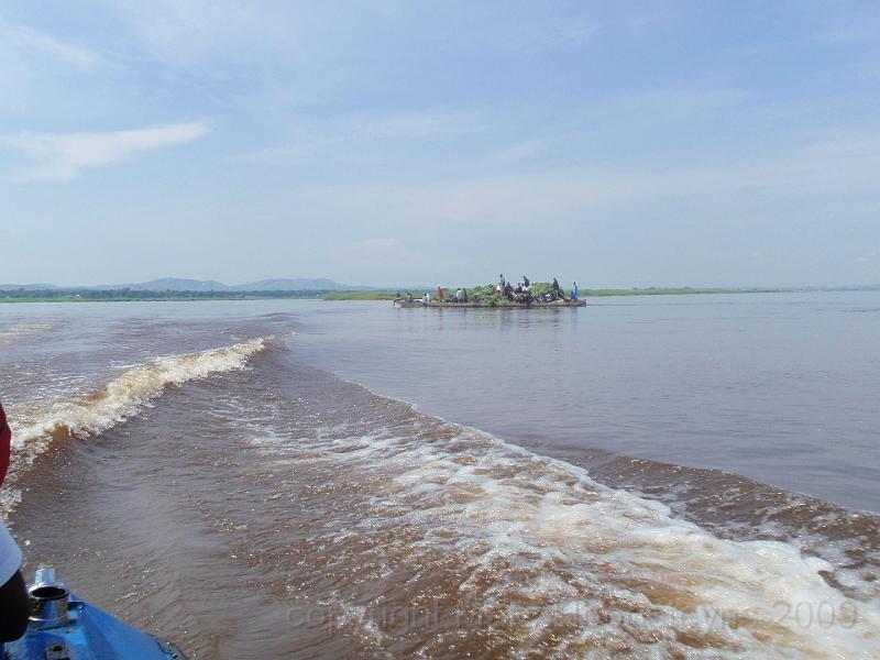 Speeding trough Stanley Pool on the Congo river with a barge on the back ground..jpg